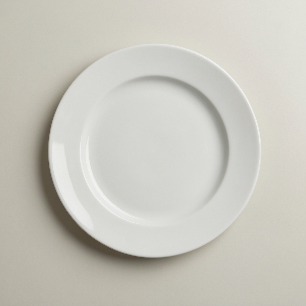 Empty plate on a pale neutral surface after a meal, minimal editorial composition, top-down perspective with clean lines